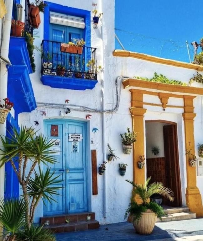Blue and yellow painted doorways of the historic houses in the old quarter of Níjar